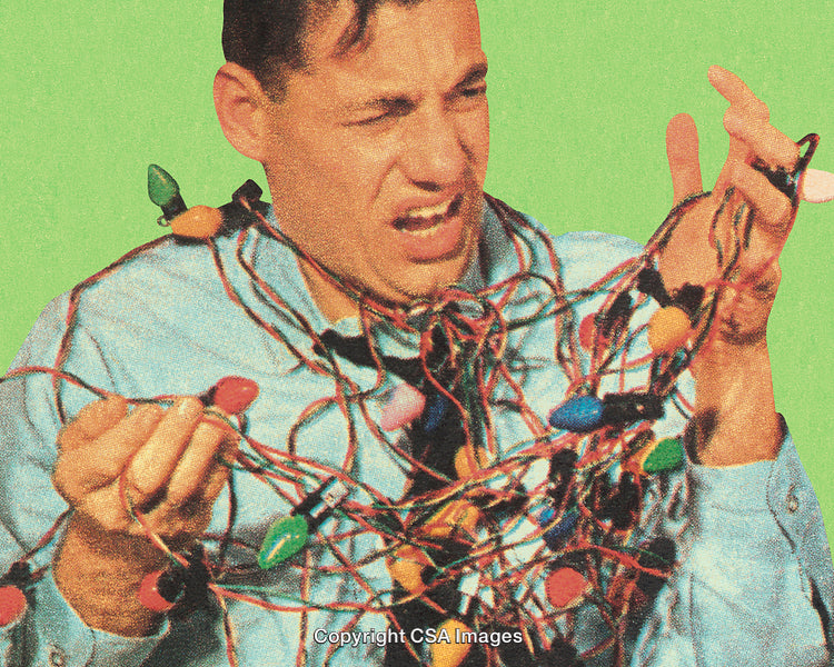 Man Tangled in Colorful Holiday Lights on Green Background