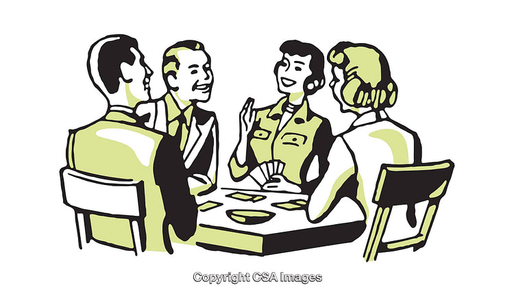 Group of People Enjoying a Friendly Card Game Around a Table