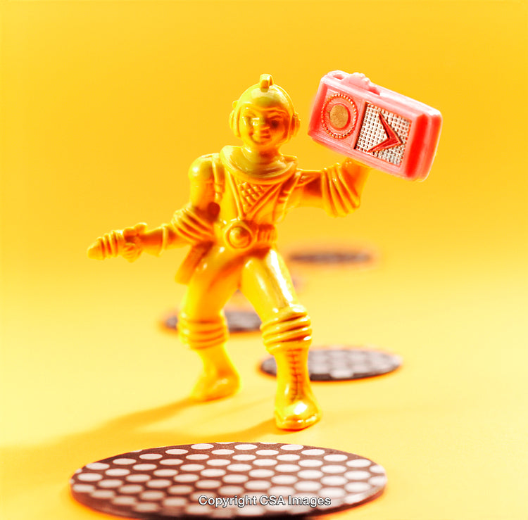 Bright Yellow Plastic Toy Robot on a Colorful Background