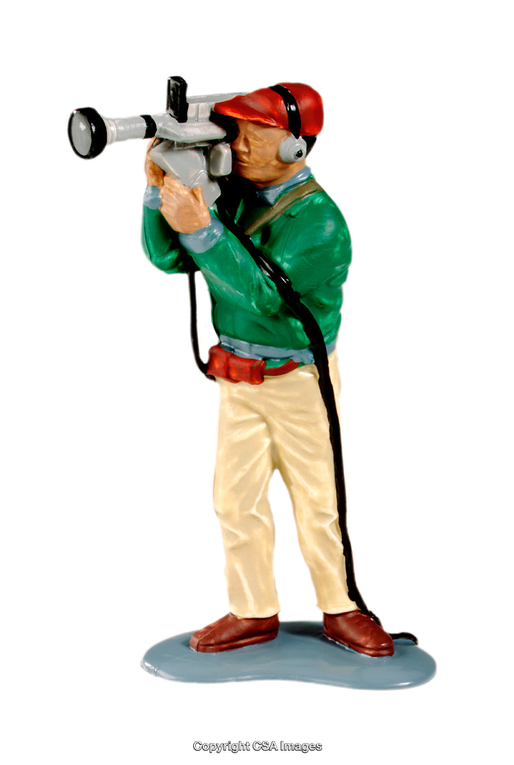 Toy Cameraman Holding a Camera Figure with Green Sweater and Red Cap