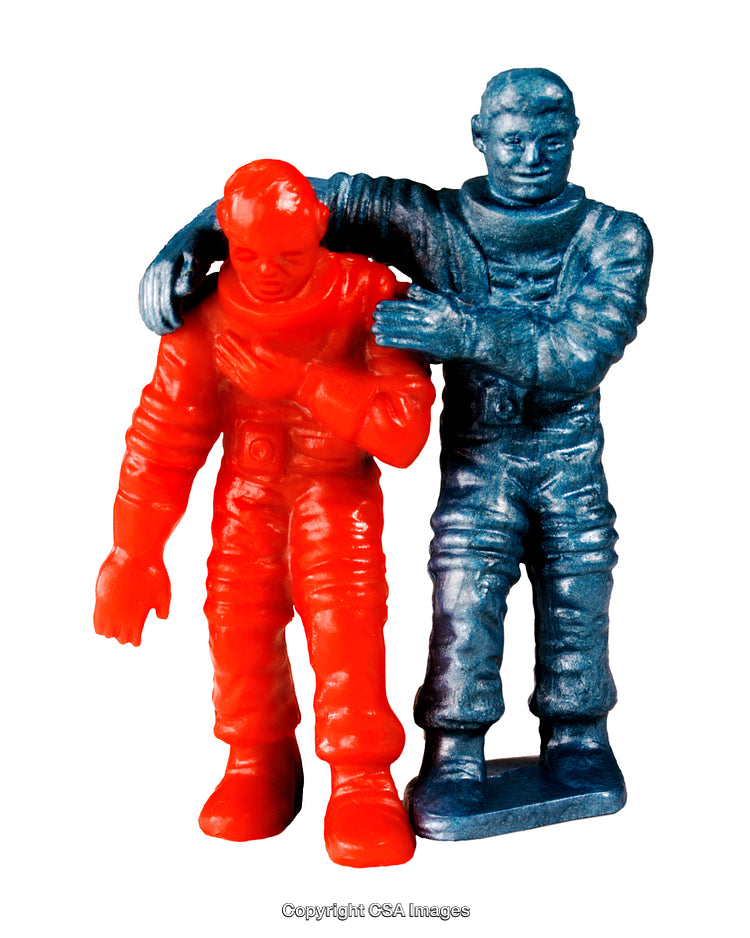 Two Colored Plastic Astronaut Figures in Emotive Scene