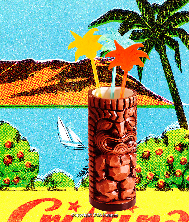 Carved Tiki Cup with Tropical Palm Stirrers in Vibrant Island Setting
