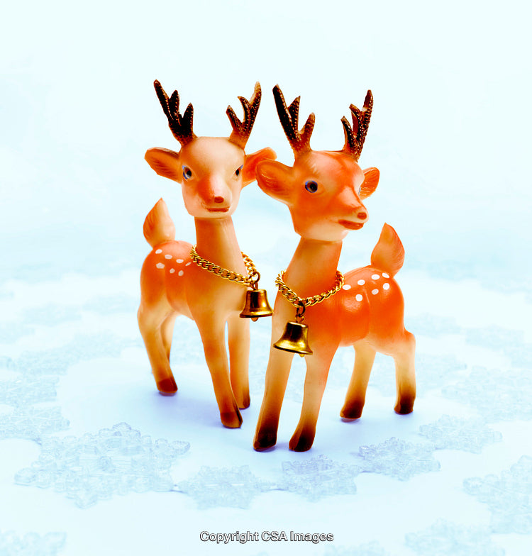 Vintage Style Plastic Reindeer Decorations with Golden Bells on a Snowflake Background