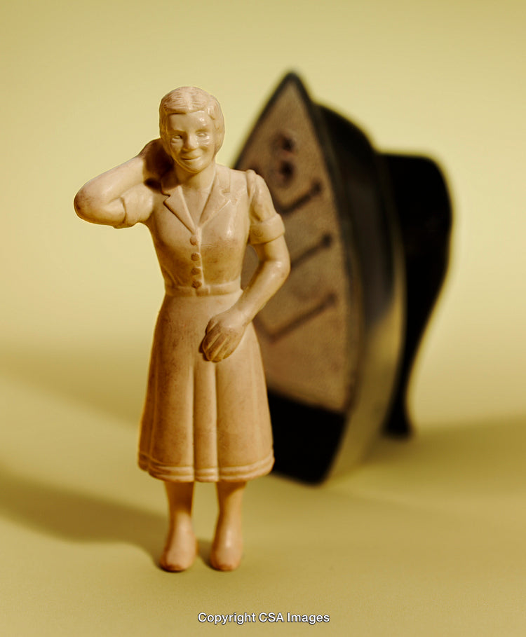 Vintage Figurine of a Woman with Retro Iron on Yellow Background