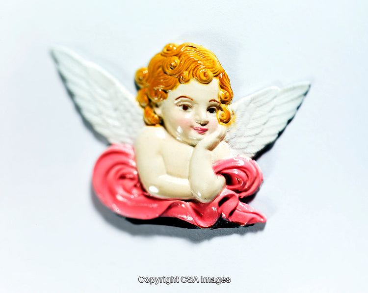 Colorful Angel Figurine with Golden Hair and White Wings on a Red Drapery