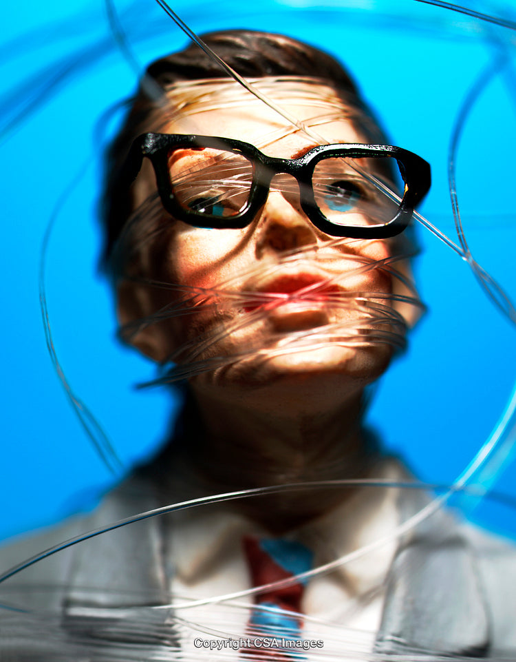 Close-Up of Figurine with Glasses Wrapped in Clear Wire on Blue Background