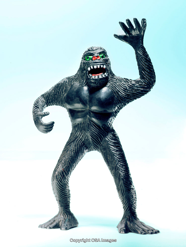 Dark Toy Figure Resembling Bigfoot With Illuminated Background