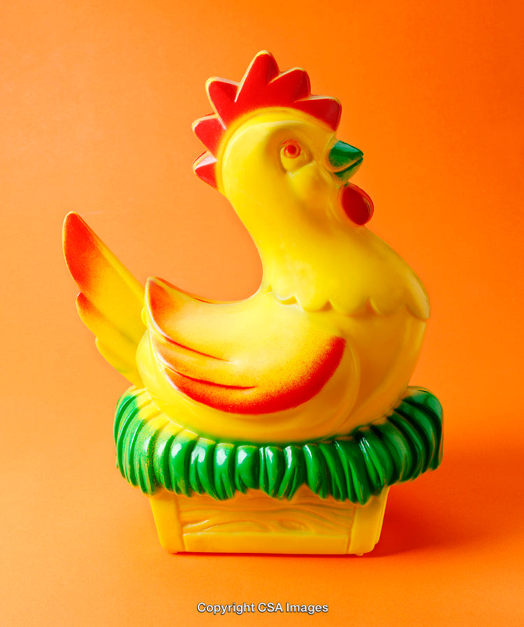 Colorful Plastic Chicken Figurine on Orange Background