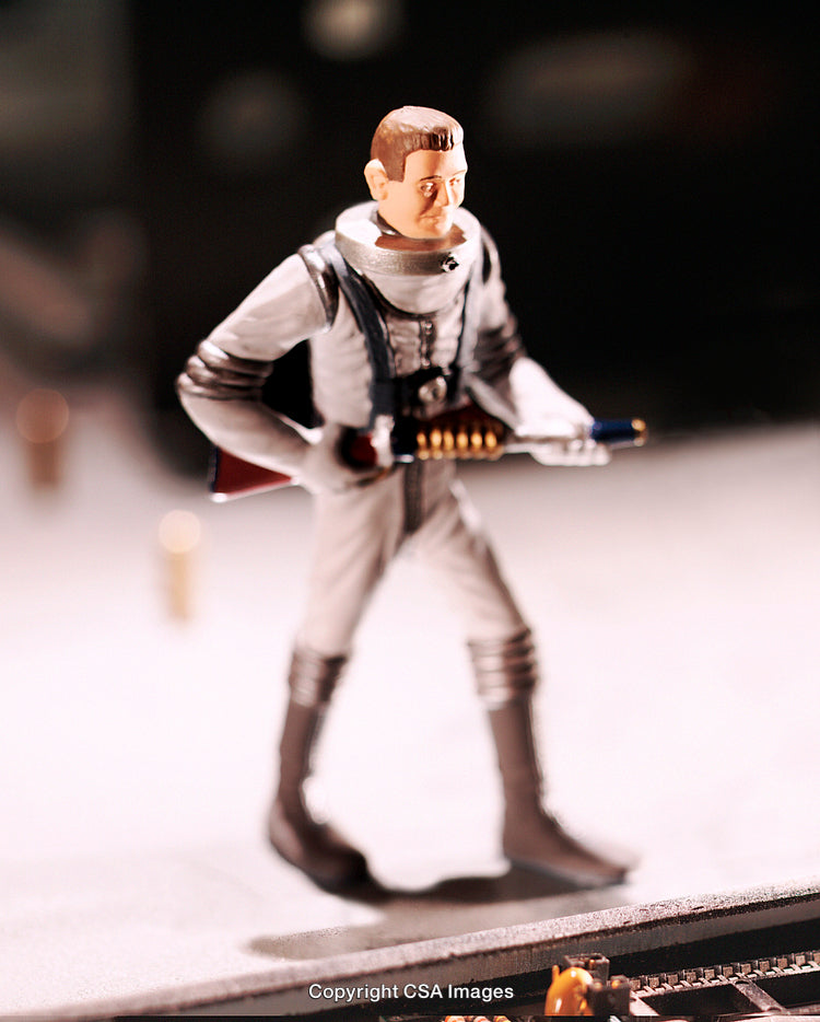 Close-Up of a Toy Figure in Astronaut Costume Holding a Futuristic Weapon