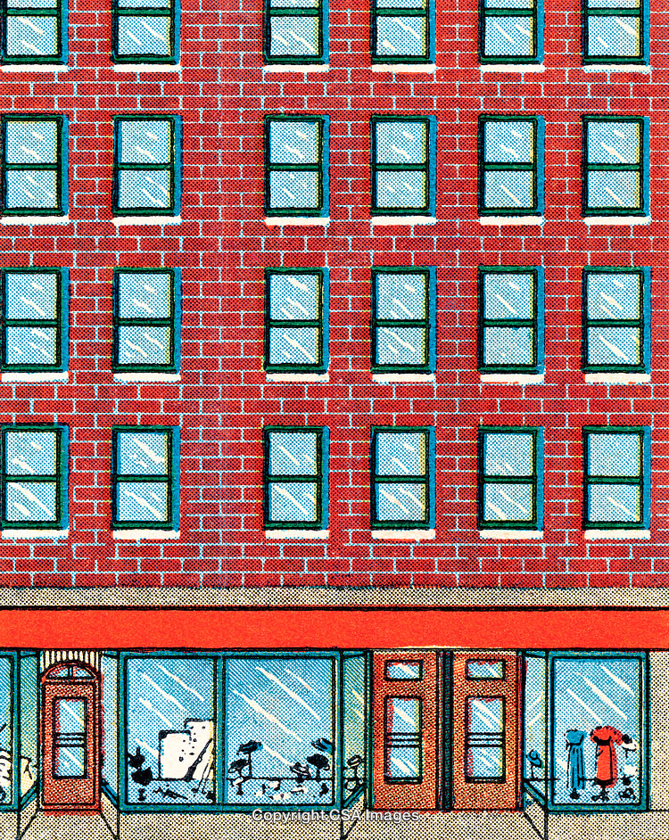 Red Brick Building Facade with Storefronts and Upper-Level Windows