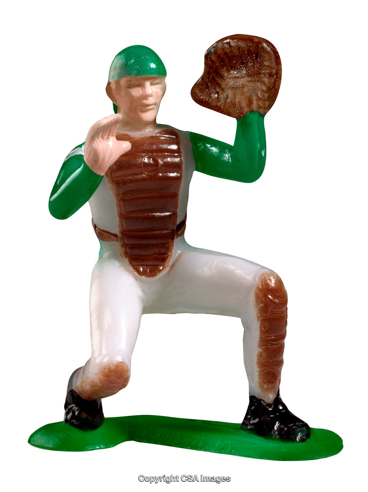 Toy Baseball Player in Green and White Catcher's Gear Posing on Field