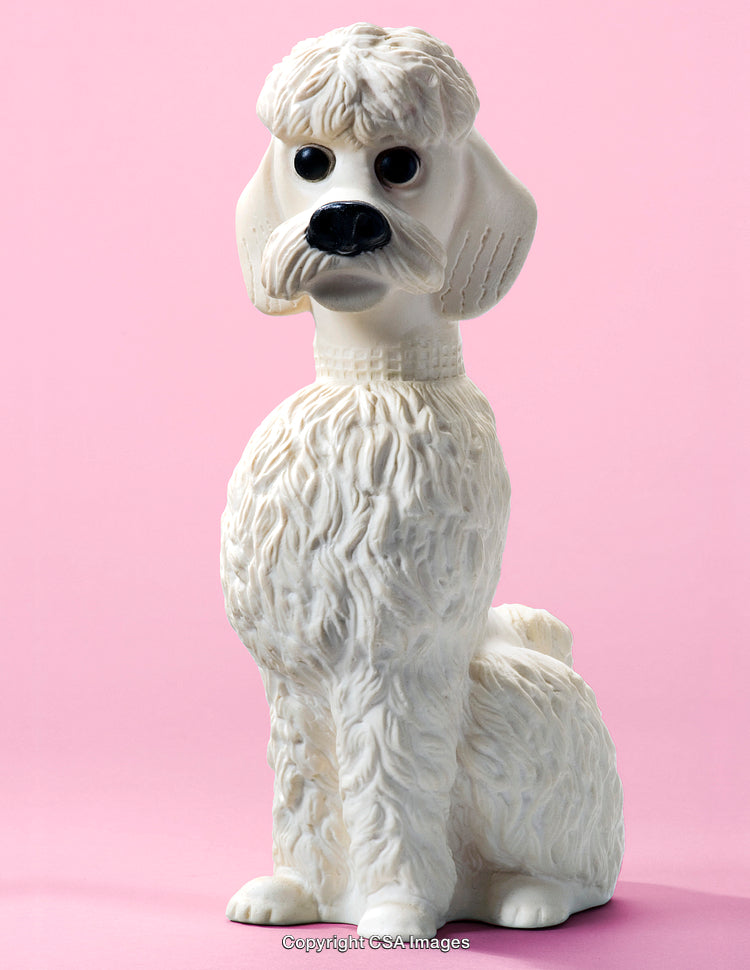 White Poodle Figurine on a Pastel Pink Background