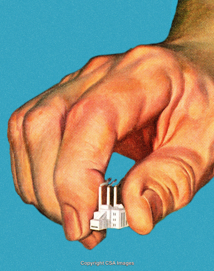 Hand Holding Miniature Factory Representing Industrial Control and Power