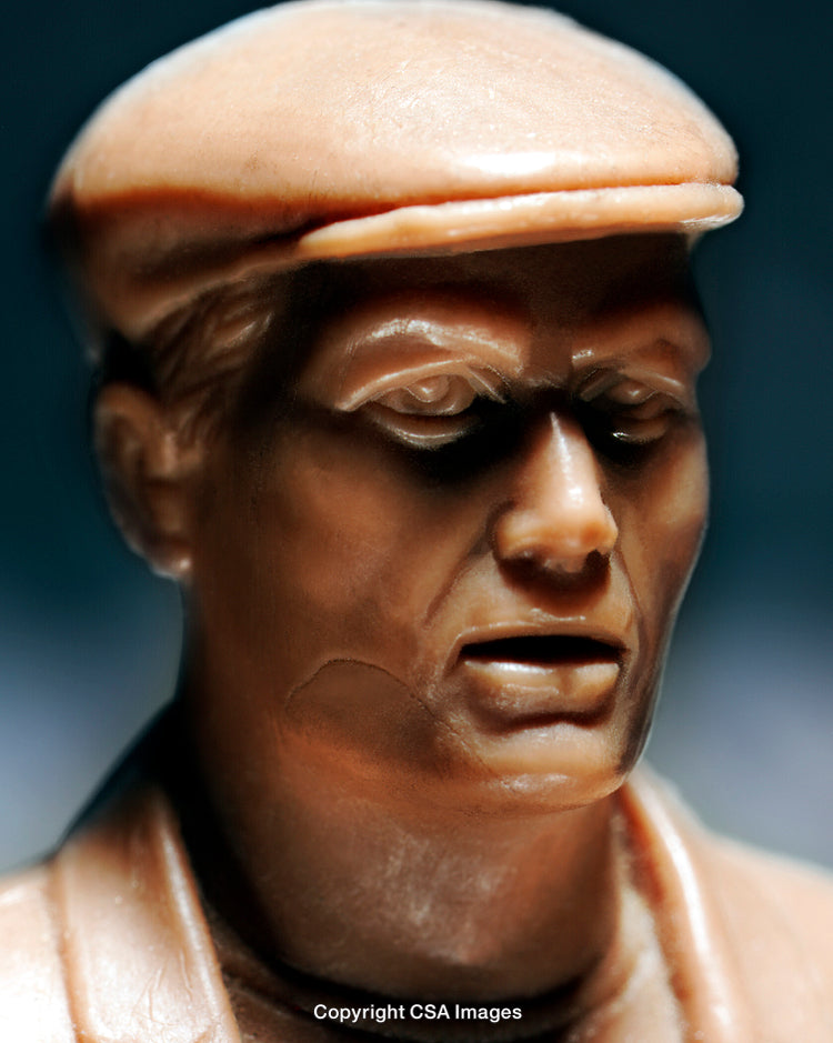 Close-up of a Brown Plastic Figurine with Detailed Facial Features