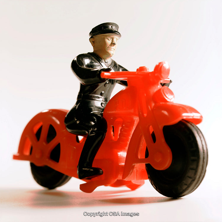 Vintage Plastic Toy Police Officer on Red Motorcycle Close-Up