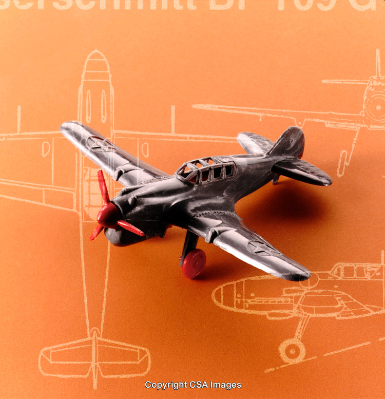 Vintage Toy Aircraft with Blueprint Patterns on Orange Backdrop
