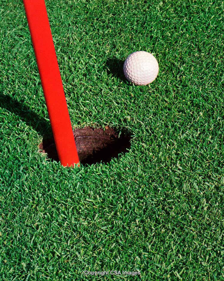 Golf Ball Near the Hole on a Vibrant Green Field