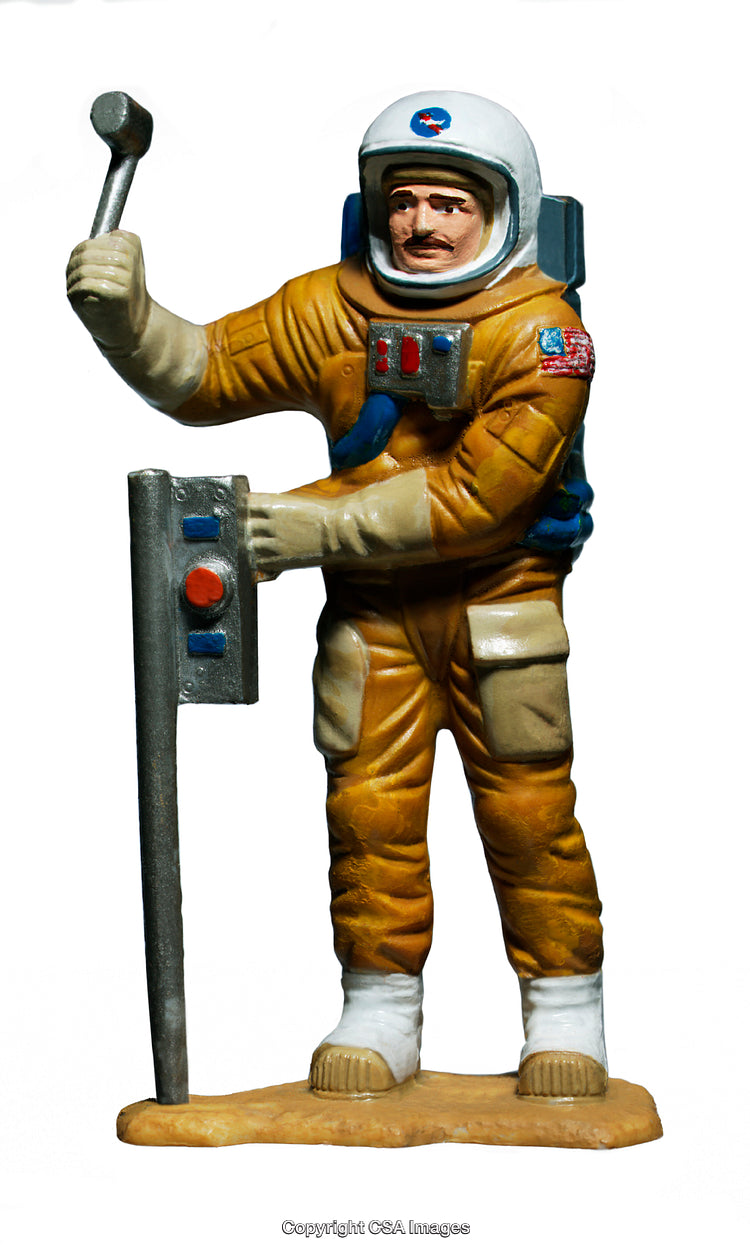 Vintage Astronaut Figurine with a Space Mission Toolkit on a White Background