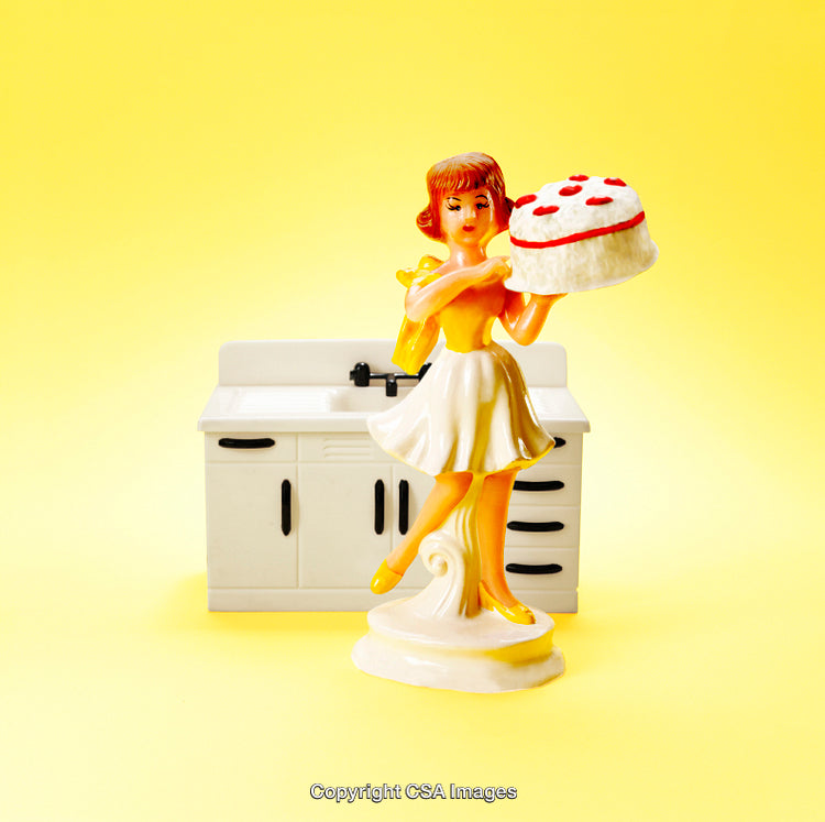 Retro Plastic Figurine Holding Cake with Mini Kitchen Background
