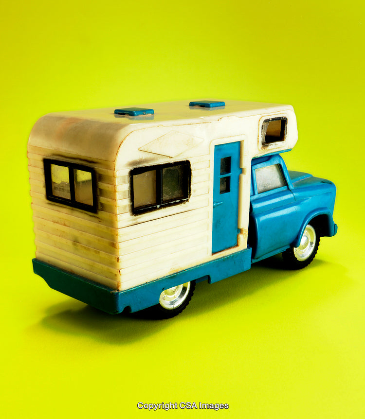 Retro Camper Toy Truck on Vibrant Yellow Background
