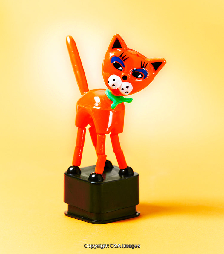 Colorful Plastic Cat Toy Against Vibrant Yellow Background