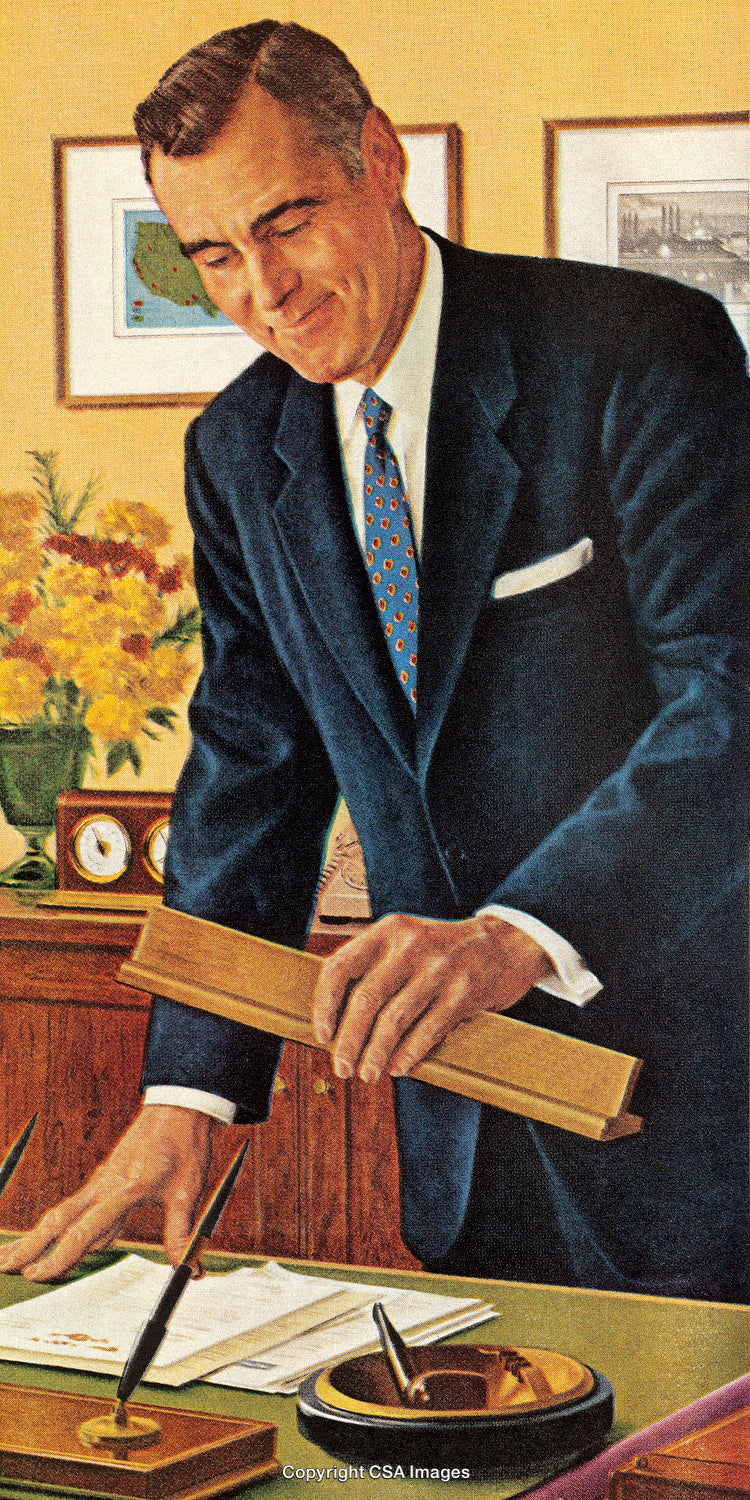 Professional Businessman Standing in an Office Setting Holding a Wooden Ruler