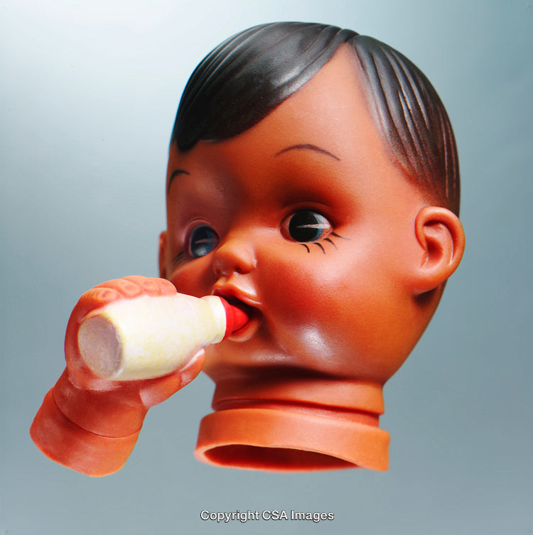 Vintage Doll Head with Bottle Against a Minimal Background