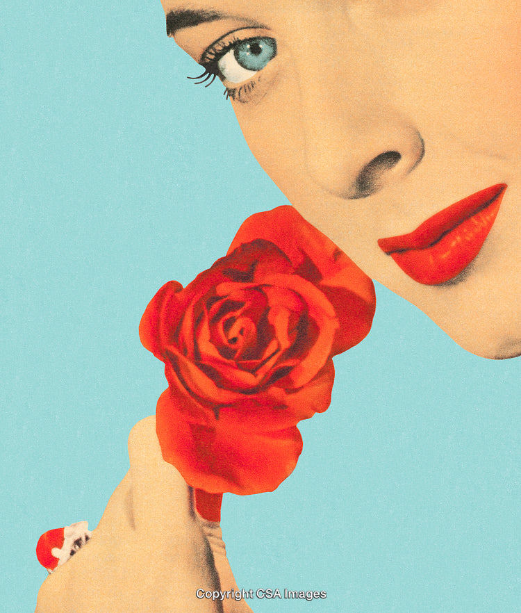 Close-Up Portrait of Woman Holding a Red Rose Against Blue Background