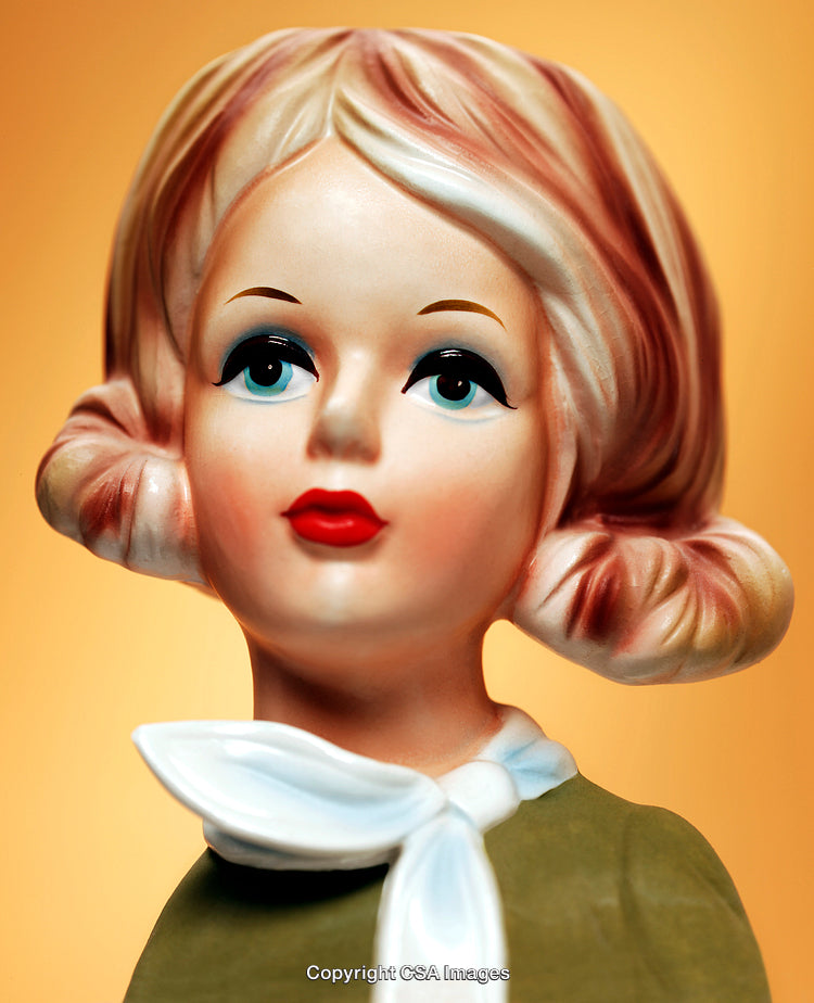 Vintage Ceramic Lady Figurine with Stylish Details on Warm Orange Background