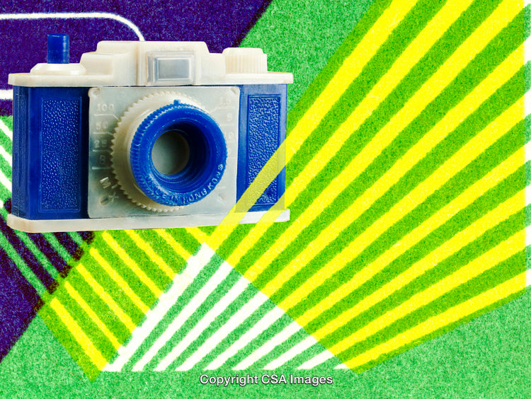 Bright Pop Art Styled Toy Camera Against Striped Colorful Background
