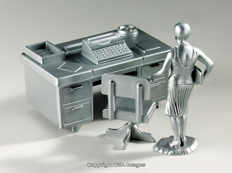Silver Miniature Office Desk and Figurine in a Modern Workplace Setting
