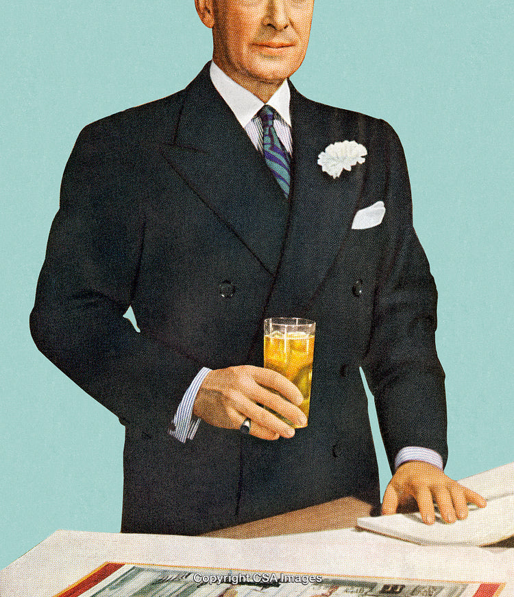 Elegant Man Holding a Glass of Refreshing Iced Drink at a Counter