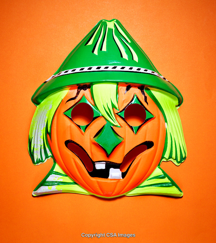 Retro Pumpkin Mask Against Bright Orange Background for Halloween Fun