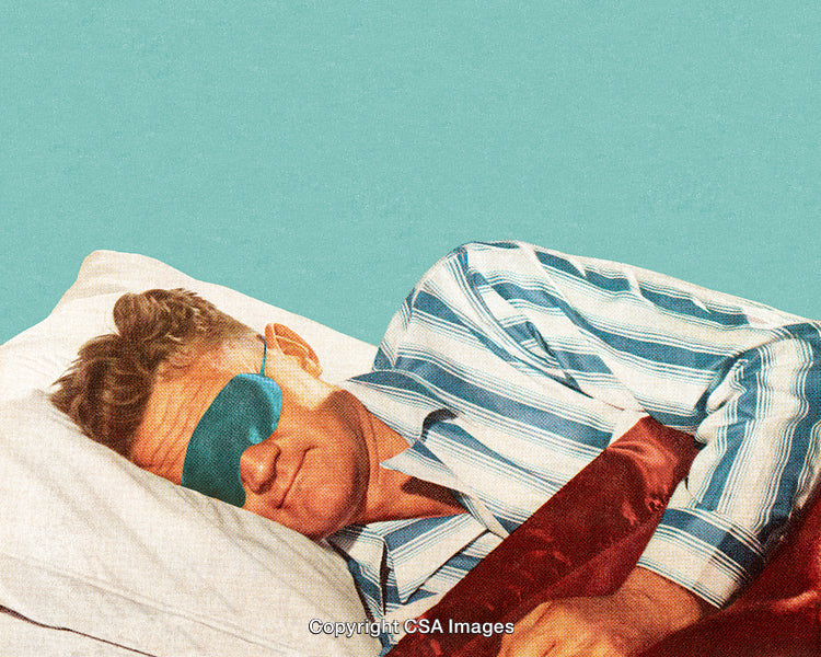 Man Wearing a Sleep Mask Relaxing in Bed with a Calm Expression