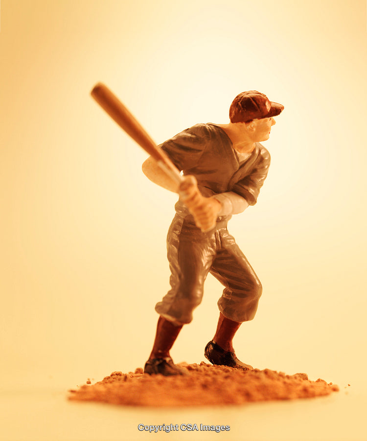 Close-Up of Plastic Baseball Player Figure Holding a Bat Ready to Swing