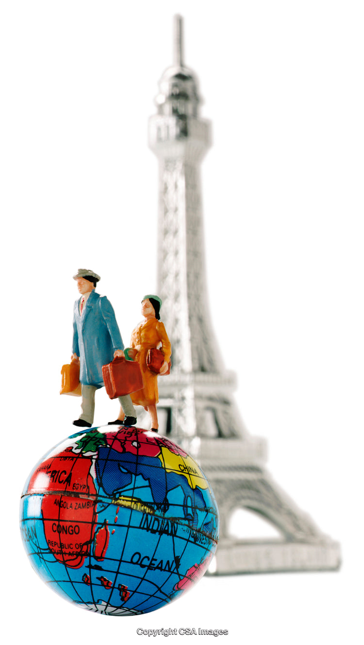 Miniature Figurines of Travelers on Globe with Eiffel Tower in Background