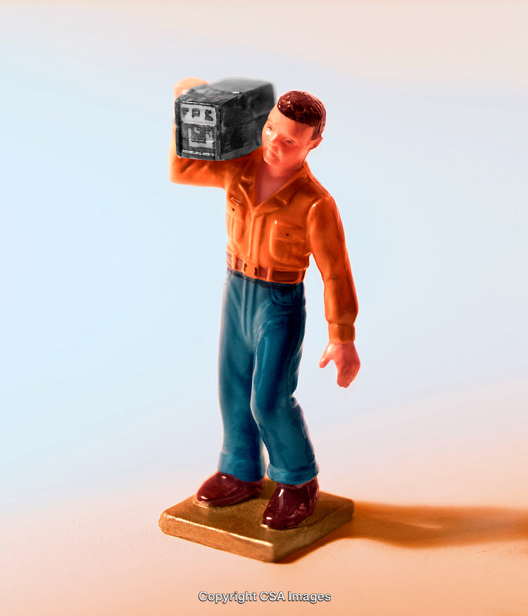 Close-Up of a Plastic Figurine Holding a Retro Object