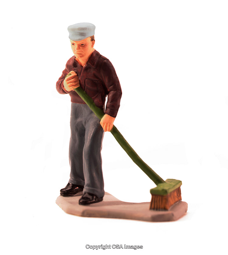 Plastic Toy Figure of a Man Sweeping with a Broom on White Background