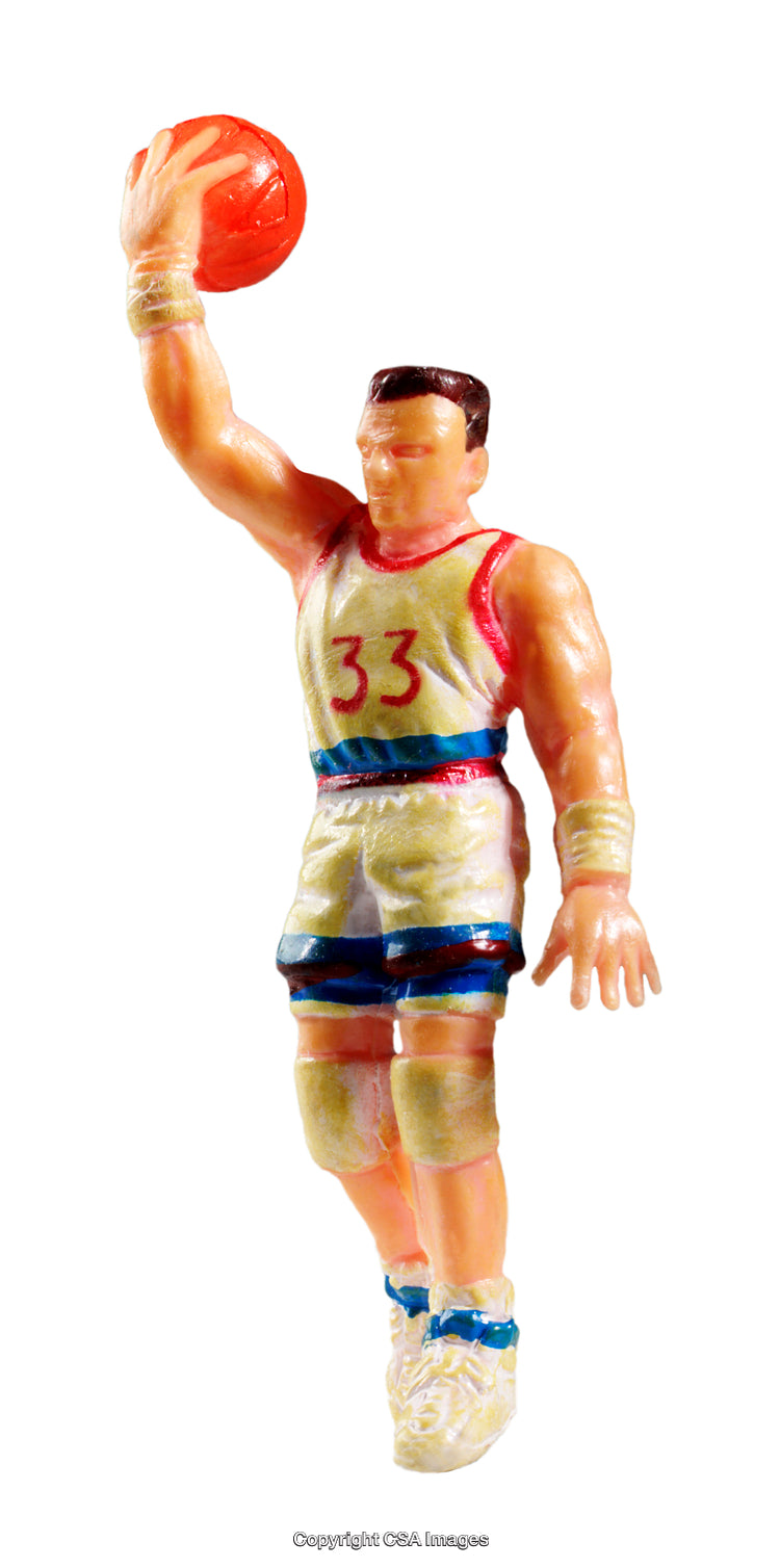 Plastic Basketball Player Figure Holding Ball in Dynamic Pose Isolated on White