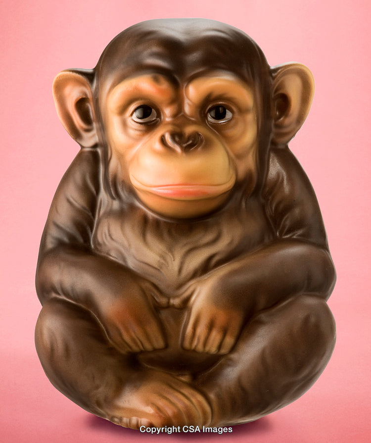 Detailed Brown Chimpanzee Figurine on Soft Pink Background