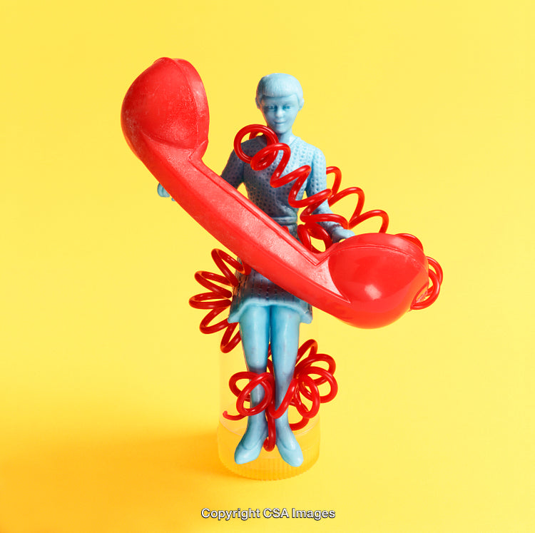 Surreal Composition with Blue Figurine and Red Telephone on Yellow Background