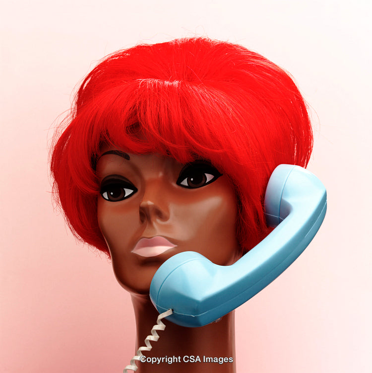 Vibrant Mannequin Head with Red Hair Holding a Blue Telephone Receiver