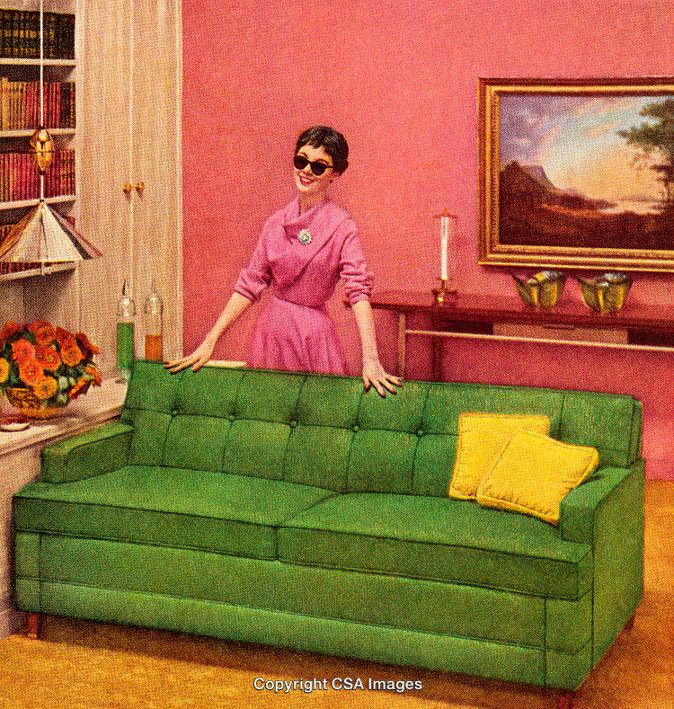 Vintage Styled Living Room Scene with Pink Walls and Green Sofa