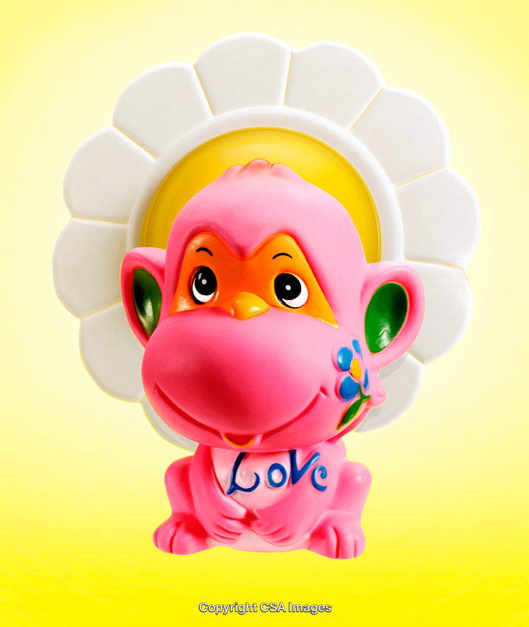 Colorful Toy Monkey Figurine with Floral Design on Bright Background