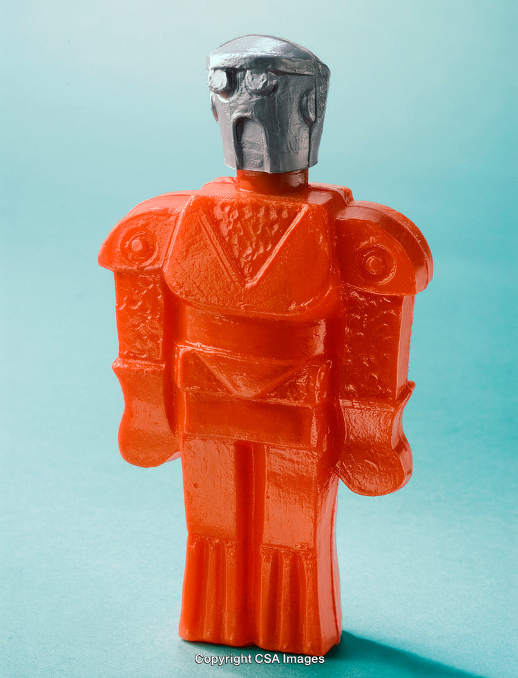 Stylized Red Plastic Robot Toy on a Light Blue Background