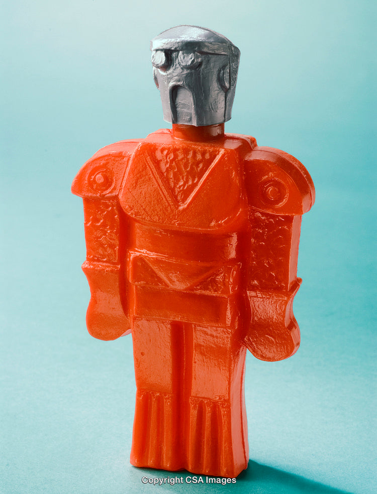 Stylized Red Plastic Robot Toy on a Light Blue Background