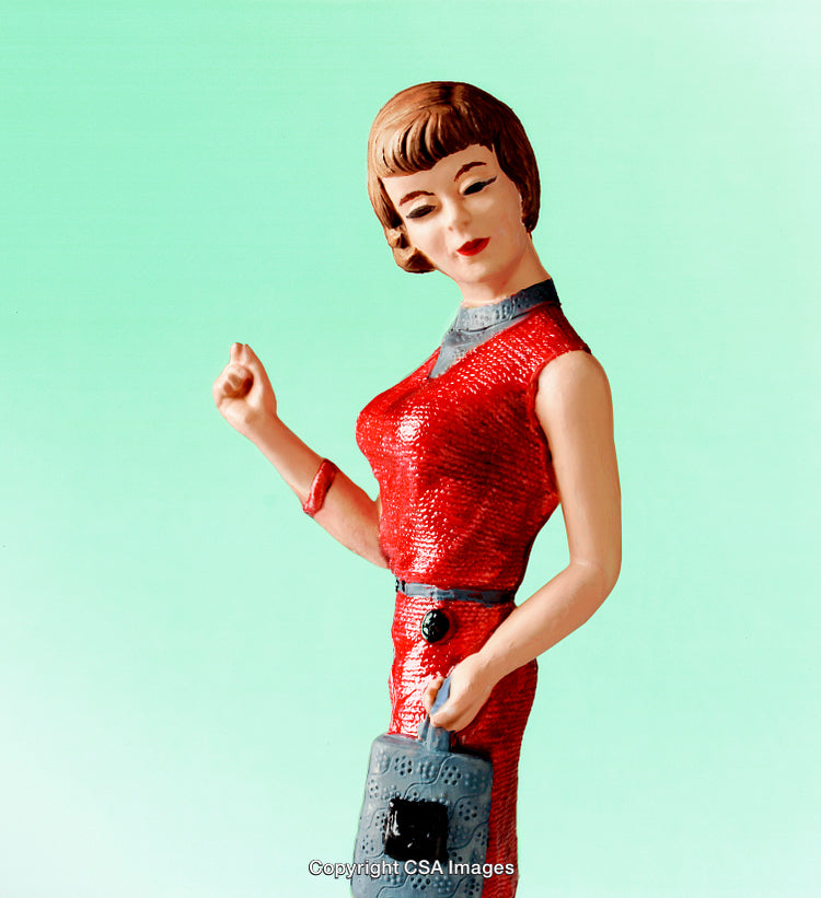 Vintage Red Figurine of Woman in Retro Style Against Teal Background