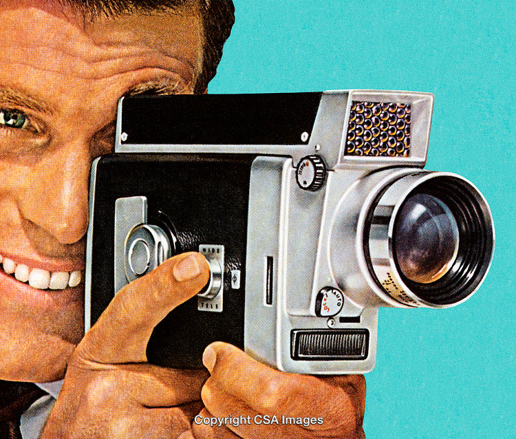 Man Holding a Vintage Camera Smiling Against a Retro Backdrop