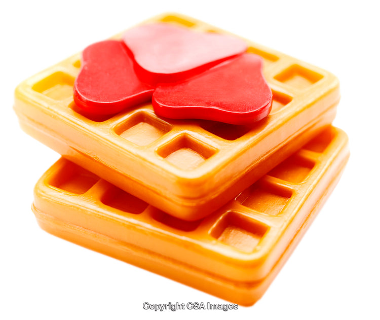 Vibrant Plastic Toy Waffles Topped with Red Heart Shapes on White Background