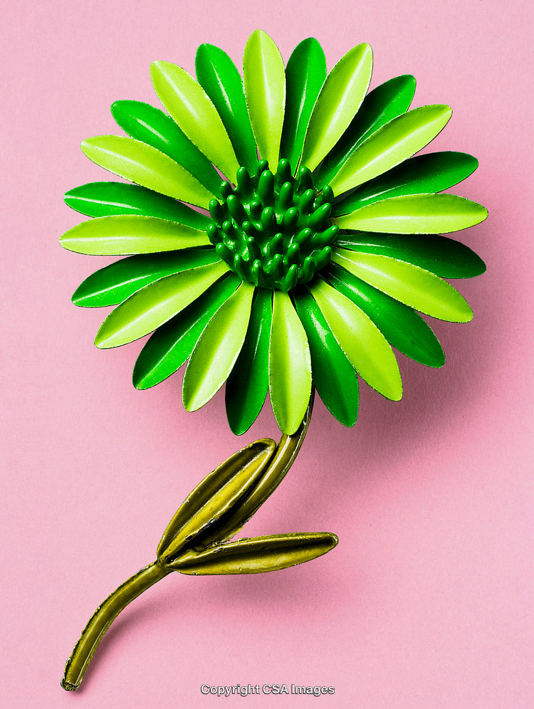 Vibrant Green Plastic Flower Against a Soft Pink Background